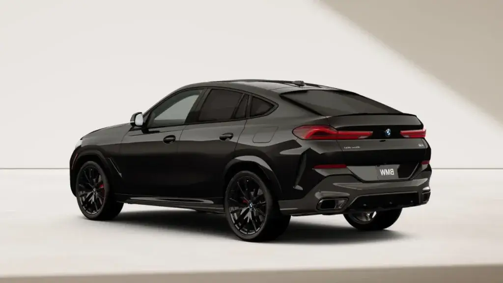 Rear three-quarter view of a black BMW X6 showing its coupe roofline
